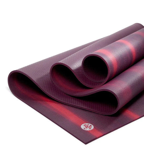 Vibrant Manduka PRO Yoga Mat in Indulge Colorfields design, made from high-density PVC material for superior support and cushioning. Slip-resistant surface ensures stability during yoga practice.